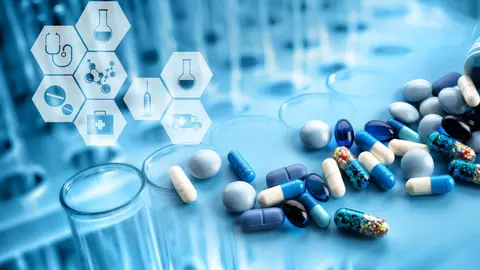 Test tubes with pills and medical icons, closeup. Health care concept.